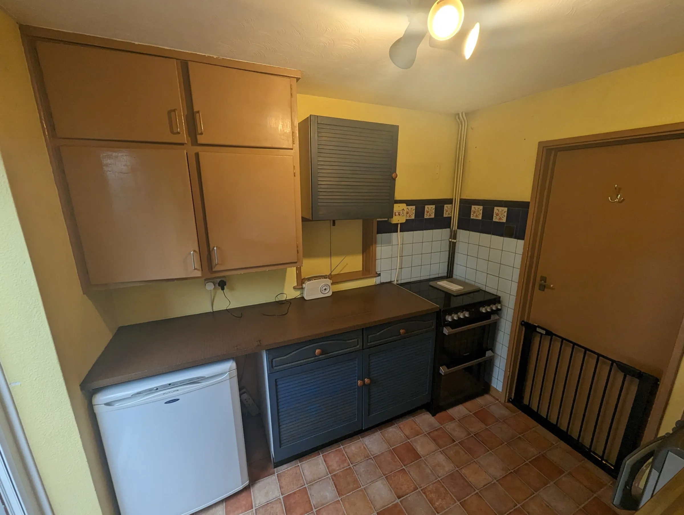 Before the refit: old brown wall cupboards and blue louvre doors