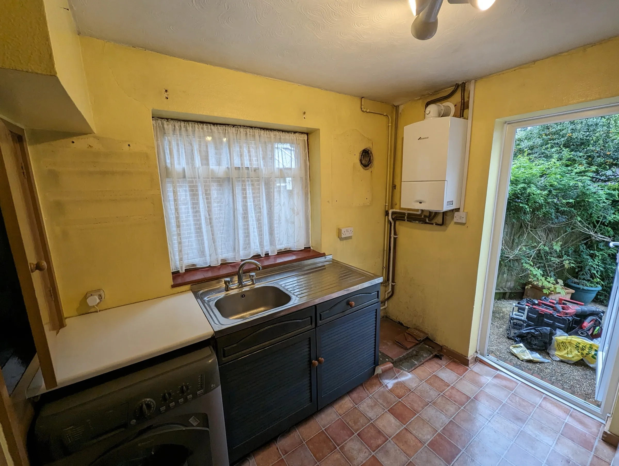 The finished galley with ceramic sink, brass tap and herringbone vinyl flooring
