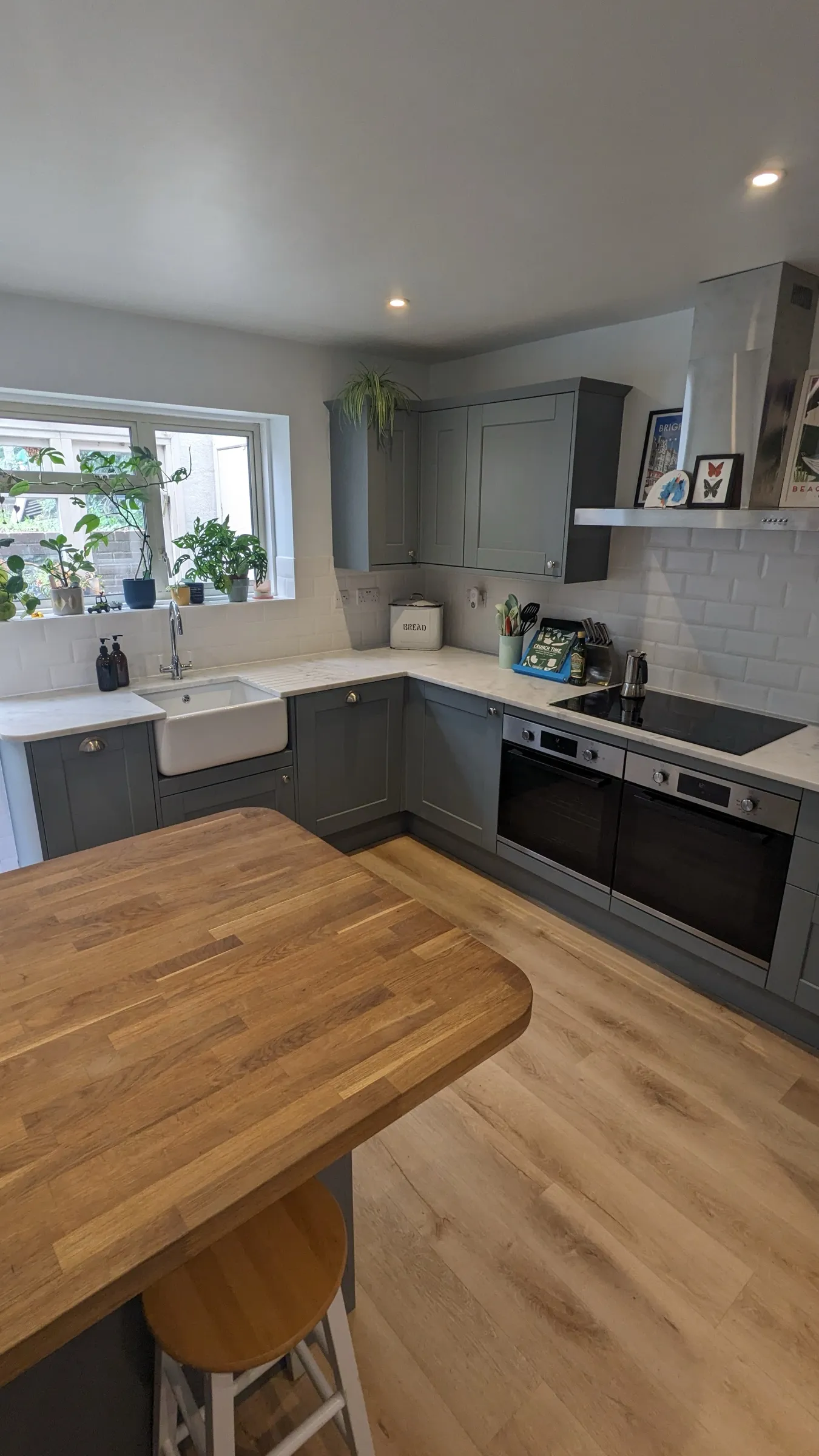 Oak-topped island looking over the Belfast sink and double ovens