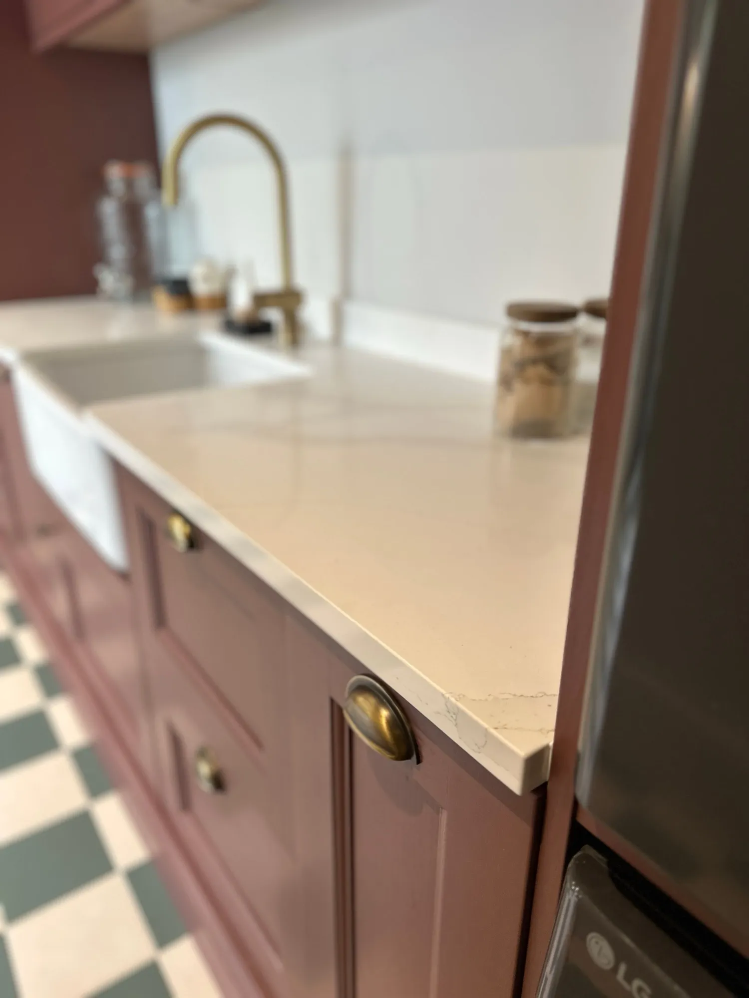 Quartz worktop edge detail with antique brass cup handles